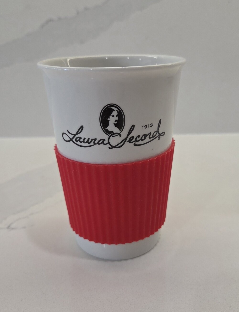 Laura Secord White Ceramic Cup with Red Silicone Grip